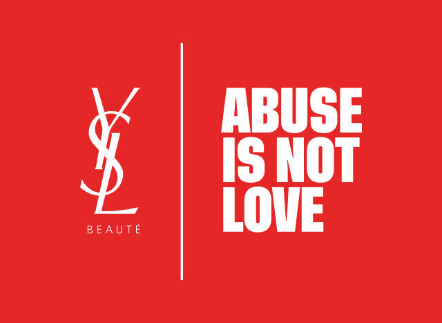 Logo YSL Beaute in bianco e il messaggio "ABUSE IS NOT LOVE" in bianco, separati da una linea verticale, su uno sfondo rosso vibrante.