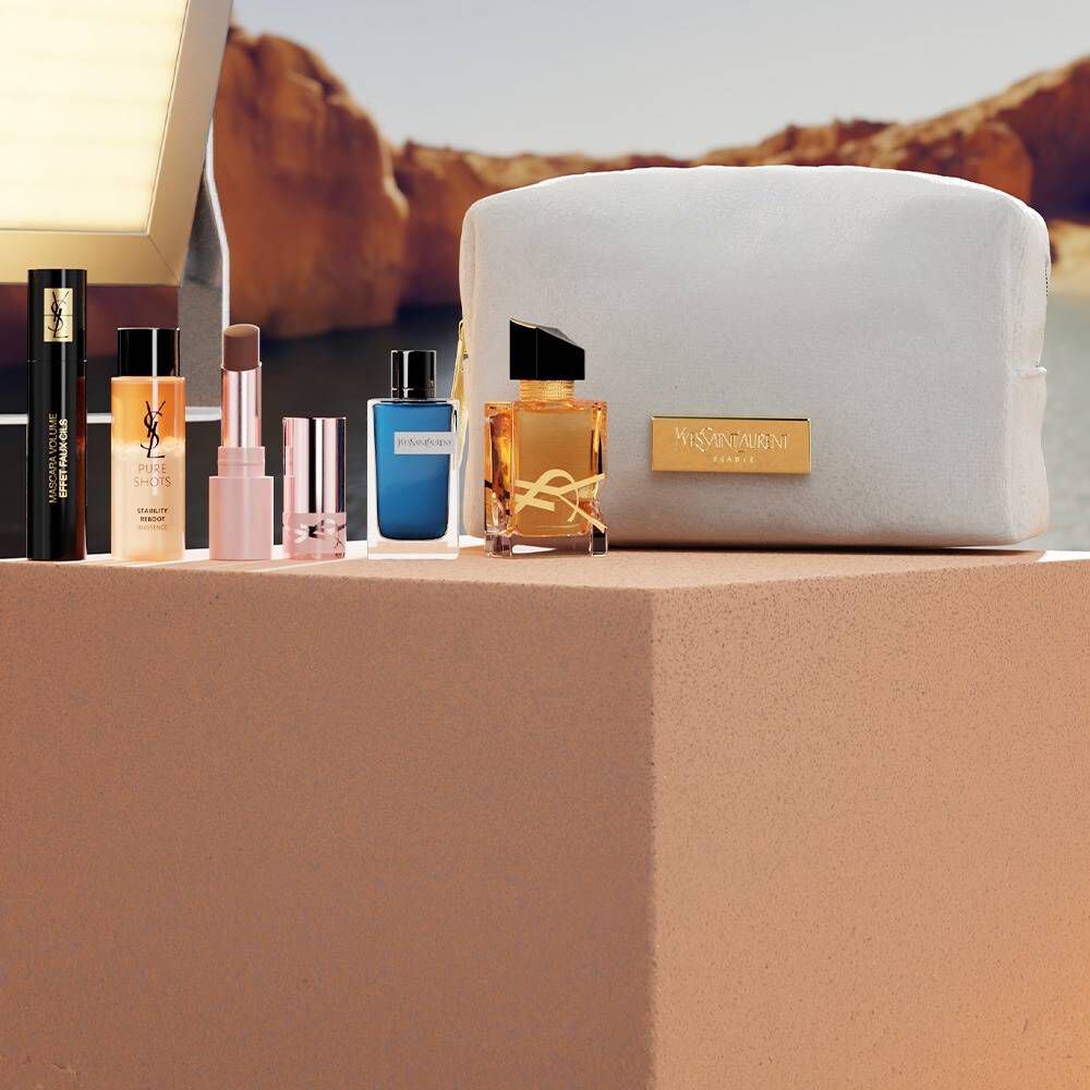 Set beauty YSL con mini prodotti e pochette bianca.