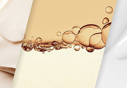 A close-up view of three different skincare textures: a creamy white lotion, a bubbly light orange gel, and a smooth beige cream, arranged side by side.