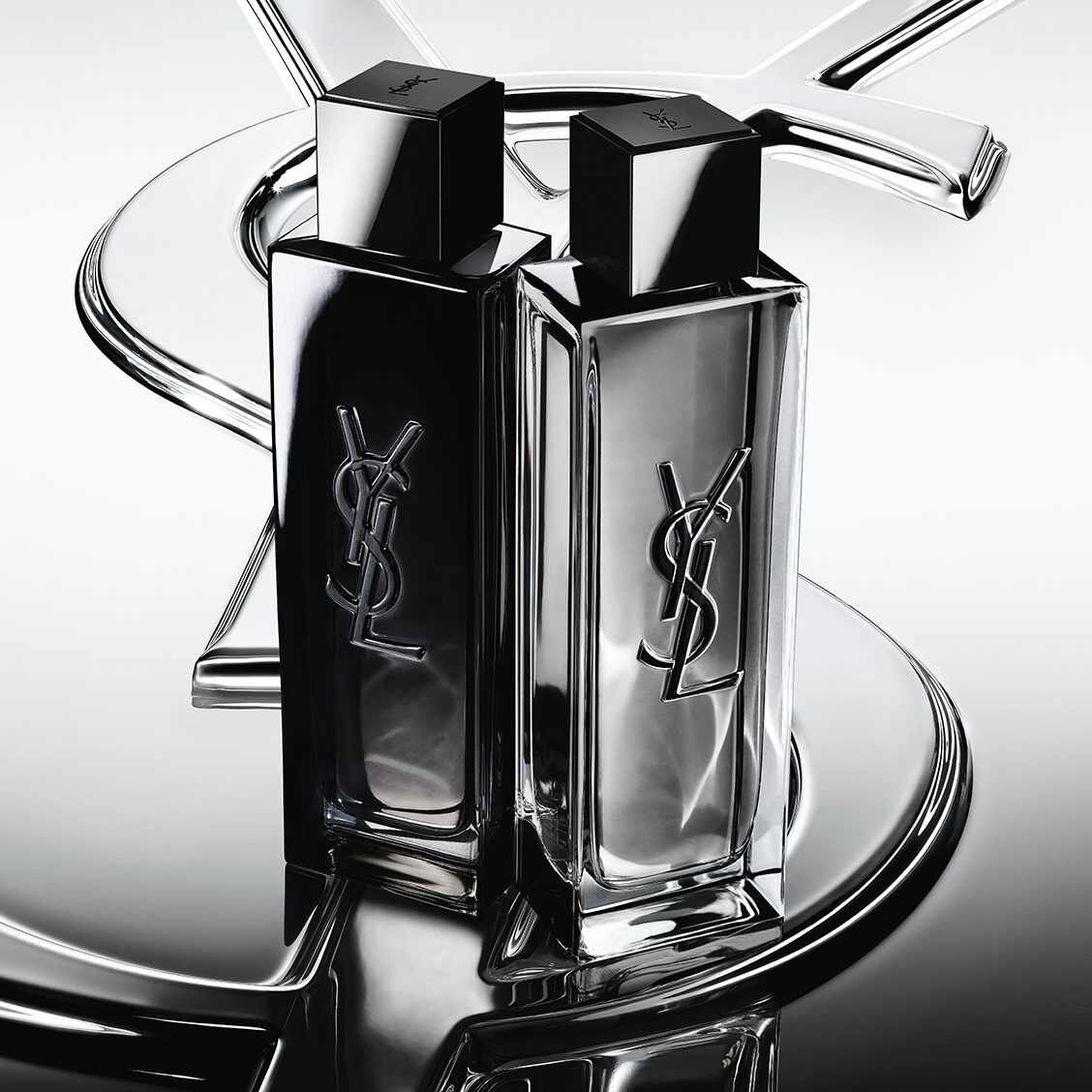 Due flaconi di profumo YSL neri e argentati