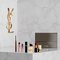 Set beauty YSL con mini prodotti e pochette.