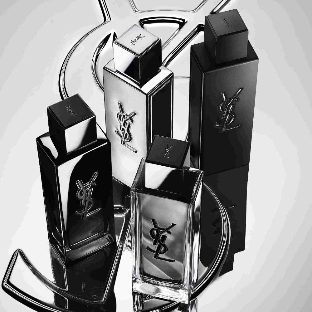 Quattro flaconi di profumo YSL neri e argentati