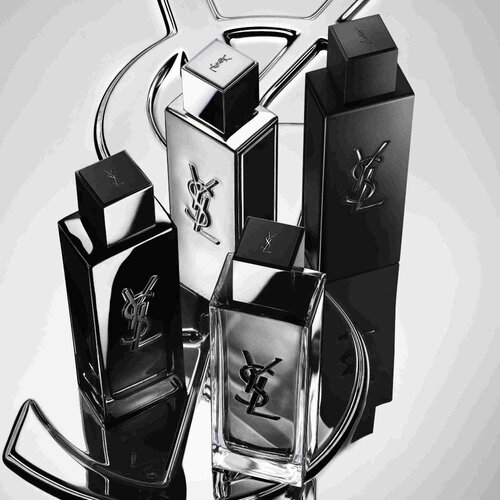 Quattro flaconi di profumo YSL neri e argentati