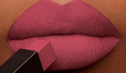 Close-up of lips applying a pink lipstick with a square-shaped applicator. The lips are smooth and well-defined, showcasing the vibrant color.