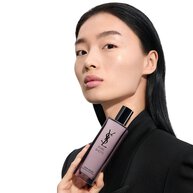 Wen, YSL Beauty model, with light skin, holding Pure Shots Youth Reload Essence-in-Lotion, highlighting hydration claims.