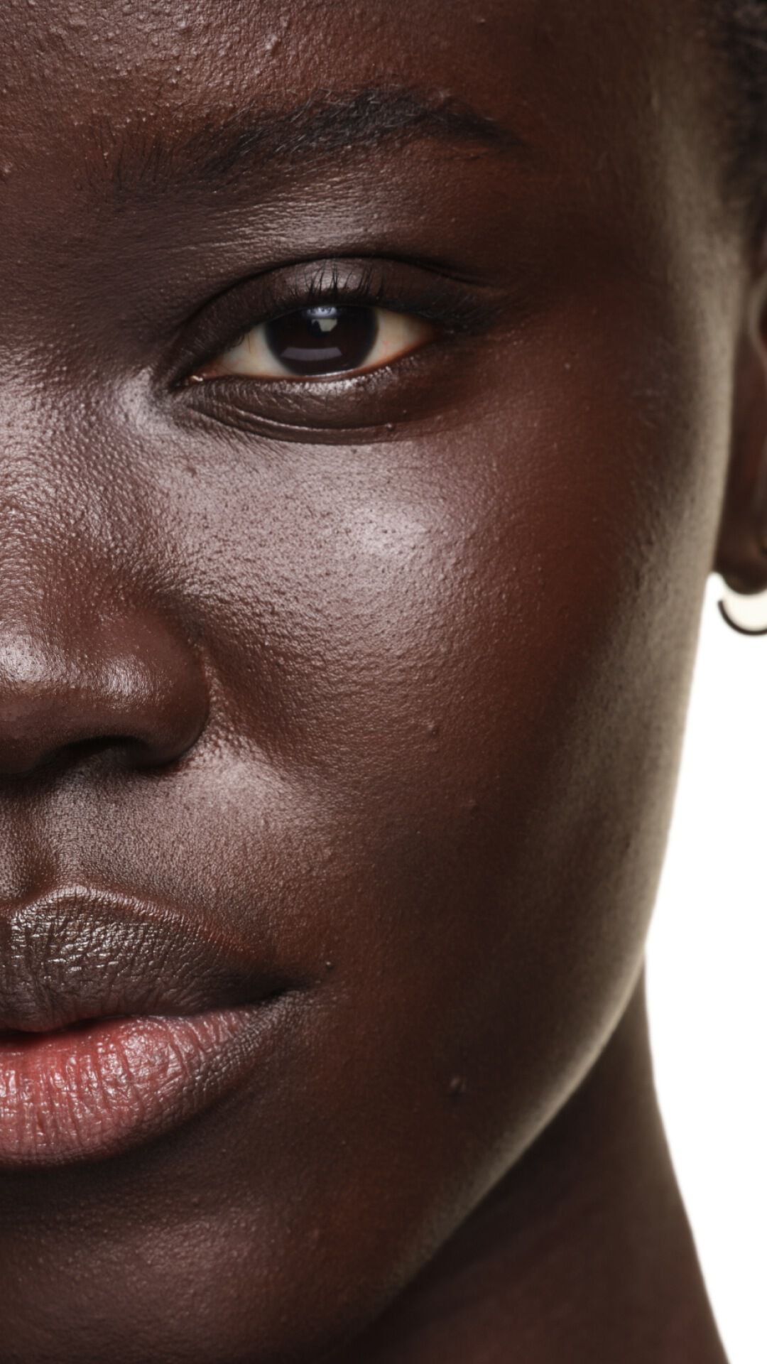 Risultato su pelle profonda con YSL SKIN AFFAIR FOUNDATION. Dettaglio che mostra un incarnato radioso, liscio e perfettamente uniforme.